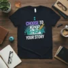 T-shirt with the quote "CHOOSE TO Keep Writing YOUR STORY" and a feather quill over an open book design
