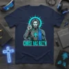 Navy blue t-shirt featuring a stylized depiction of Jesus in futuristic armor with the text "Christ Has Rizz'n" in neon