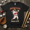 Christmas Classic Holiday Hitter t-shirt featuring Santa Claus playing baseball, wearing a Santa hat and uniform, with snow falling