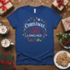 Christmas is my LOVE LANGUAGE text design with festive lights and gift graphics on a blue t-shirt