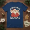Christmas Kansas t-shirt design with Santa Claus holding a mug, surrounded by snow and windmills, inside the state outline
