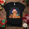 Christmas Poodle Dog T-Shirt with a happy poodle wearing a Santa hat and surrounded by festive lights and gifts