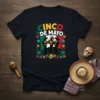 Cinco de Mayo t-shirt with a mariachi band playing in front of the Mexican flag, surrounded by flowers and festive