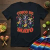 Cinco de Mayo t-shirt design featuring mariachi skeletons playing instruments under festive lettering