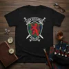 Clan Buchanan Scotland crest design featuring tartan pattern, red lion rampant, and crossed swords on a black t-shirt