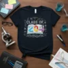 Class of 2024 graduation t-shirt featuring science icons, a graduation cap, and a book with colorful numbers