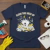 Navy blue t-shirt with "CLEAN THIS MESS UP" text and a graphic of a vacuum cleaner sucking up a chaotic