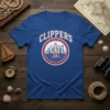 Royal blue t-shirt with 'CLIPPERS' text above a circular logo featuring a city skyline and a sailboat in the water
