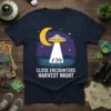 Close Encounters Harvest Night t-shirt design featuring a UFO, moon, and stick figures being abducted