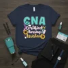 CNA Certified Nursing Assistant t-shirt with sunflowers and medical icons, featuring teal and yellow text