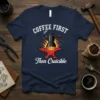 Coffee First Then Cruicible text with a coffee pot on an anvil over flames graphic on a navy t-shirt