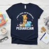 Pediatrician t-shirt with "Coffee, Scrubs, and Tiny Human Hugs" text, featuring a giraffe holding a baby and medical scrubs