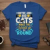 Coffee and Cats Make the World Go Round quote with cat and coffee cup graphics on a blue t-shirt