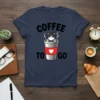 Coffee To Go T-Shirt with a grumpy cat peeking out of a coffee cup. Features bold text and a heart