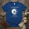 Blue t-shirt with "Compassion Ranch" text and a circular logo featuring a horse, dog, and puppy