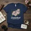Connecticut state outline with pink Mountain Laurel flowers and text "Connecticut Mountain Laurel" on a navy t-shirt