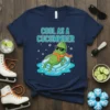 Cool As A Cucumber text with a cartoon pickle character relaxing on ice, wearing sunglasses and a scarf, on a