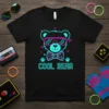 Black t-shirt with a neon cyan and magenta "COOL BEAR" text and a graphic of a teddy bear wearing sunglasses