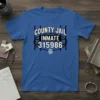 County Jail Inmate 315986 text design with barbed wire and fingerprint graphic on a blue t-shirt