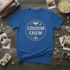 Blue t-shirt with "Cousin Crew" text in a circle graphic featuring icons of handshake, people, and gems