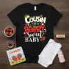 Black t-shirt with "Cousin of a BERRY Sweet Baby" text and strawberry graphics