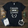 Navy blue t-shirt with white text reading "Cousin of the Groom" adorned with wedding rings and a laurel wreath graphic