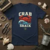 Crab Shack t-shirt design featuring a red crab, ocean waves, and nautical compass, perfect for seafood lovers and beachwear