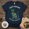 T-shirt with "Crafty Creations Where Threads and Dreams Unite" text and a cat filled with sewing icons