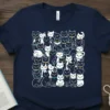 Navy blue t-shirt featuring a dense pattern of various cartoon cats, with the text "Crazy Cat Person & Proud!" visible
