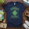 Navy t-shirt with green text "Create a Kinder Planet The World Could Always Use More Kindness" and apple graphic