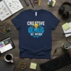 Creative Genius At Work t-shirt design with white and blue text and a lightbulb graphic