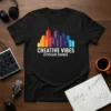 Creative Vibes Cityscape Sounds t-shirt design featuring a colorful cityscape skyline and white text
