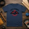 Navy blue t-shirt featuring the Crest Framing logo with mountains and gear graphic