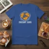 Croissant Squad text with a circular graphic of three croissants on a royal blue t-shirt