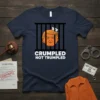 Crumpled Not Trumpled political humor t-shirt design featuring a caricature behind bars