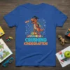 Orange T-Rex dinosaur wearing graduation cap and backpack, with text "NEW CRUSHING KINDERGARTEN!" on a blue t-shirt