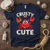 Crusty But Cute t-shirt design featuring a cartoon crab with a bandana and a piece of wood, with bold text