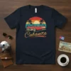 Cubanita text with retro sunset and classic red convertible car design on a navy t-shirt