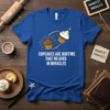Blue t-shirt with the text "Cupcakes Are Muffins That Believed In Miracles" and illustrations of a muffin transforming into a