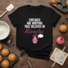 Black t-shirt with the text "Cupcakes are Muffins That Believed in Miracles" and a graphic of a smiling cupcake with