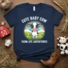 Cute baby cow with rainbow and flowers, text "CUTE BABY COW FARM LIFE ADVENTURES" on a navy t-shirt