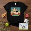 Cute cartoon cow eating grass behind a fence with flowers, on a black t-shirt, colorful striped background