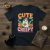 Cute Creepy Halloween T-Shirt design with a ghost, pumpkins, and bats. Text says "CUTE CREEPY" in retro font