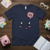Navy blue t-shirt with a cute cartoon face and a pink speech bubble saying "Hey!"