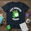Cute green monster with yellow horns and fangs, text "CUTE MONSTER FRIEND" on a navy t-shirt