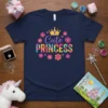 Navy blue t-shirt with "Cute Princess" text surrounded by colorful flowers and a golden crown graphic