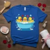 Cute rubber ducks bathing in a tub with bubbles, one holding a rose, on a blue t-shirt