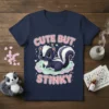 Cute But Stinky t-shirt design featuring a cartoon skunk on a cloud with pink and blue text