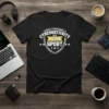 Black t-shirt with white text "Cybersecurity Is A Team Sport" in a shield graphic, designed for tech professionals