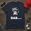 Dab Raccoon T-Shirt with a cartoon raccoon doing the dab dance pose and the text "DAB RACCOON"